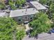 Aerial view of brick apartment building and lush green surroundings in an urban setting at 2100 N Franklin St # 8, Denver, CO 80205