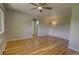 Spacious bedroom with hardwood floors, a ceiling fan, and natural light, creating a comfortable and inviting atmosphere at 2100 N Franklin St # 8, Denver, CO 80205