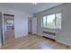 Well-lit bedroom with hardwood floors, a window with a view, and access to a closet and other rooms, providing a comfortable layout at 2100 N Franklin St # 8, Denver, CO 80205