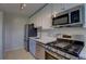 Modern kitchen featuring stainless steel appliances, ample cabinet space, and stylish countertops at 2100 N Franklin St # 8, Denver, CO 80205