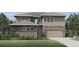 Charming two-story home with a mix of stone and siding, plus an attached two-car garage and a well-manicured front yard at 6309 Cristobal Pt, Parker, CO 80134
