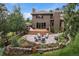 An aerial view of the home's backyard, deck, patio and landscaping highlighting its outdoor living space at 1456 Shavano Ct, Evergreen, CO 80439