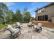 Backyard patio with outdoor seating, deck, and beautiful landscaping, ideal for outdoor living and entertaining at 1456 Shavano Ct, Evergreen, CO 80439