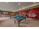 Finished basement with multiple recreational spaces including a pool table, poker table, and popcorn machine at 1456 Shavano Ct, Evergreen, CO 80439