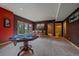 Spacious finished basement with a poker table and additional seating, perfect for entertaining or relaxing at 1456 Shavano Ct, Evergreen, CO 80439