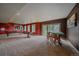 Large finished basement with multiple windows for natural light, carpet flooring, and space for games and activities at 1456 Shavano Ct, Evergreen, CO 80439