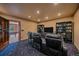 Media room with theater seating and custom-built bookshelves, perfect for entertaining at 1456 Shavano Ct, Evergreen, CO 80439