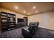 Media room with theater seating and custom-built bookshelves, perfect for entertaining at 1456 Shavano Ct, Evergreen, CO 80439