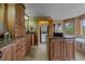 Well-lit bathroom featuring wooden cabinets, double sinks, an island, and a combination tub/shower at 1456 Shavano Ct, Evergreen, CO 80439