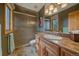 Full bathroom with glass-door shower, wood cabinets, and tile flooring at 1456 Shavano Ct, Evergreen, CO 80439