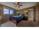 Bedroom with dark-stained furniture, textured walls, and an ensuite bathroom at 1456 Shavano Ct, Evergreen, CO 80439
