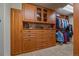 Walk-in closet with custom wooden built-ins and shelves for ample clothing and storage at 1456 Shavano Ct, Evergreen, CO 80439