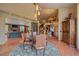 Open-concept dining room flows into living areas and features hardwood floors and pendant lighting at 1456 Shavano Ct, Evergreen, CO 80439