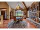 An elegant dining room with a fireplace, a round table, and a large window at 1456 Shavano Ct, Evergreen, CO 80439