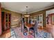 Dining room featuring hardwood floors, a wooden table with leather chairs, and custom wood built-in cabinetry at 1456 Shavano Ct, Evergreen, CO 80439