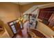 Grand foyer with wood staircase, decorative chandelier, and views of the living room and dining area at 1456 Shavano Ct, Evergreen, CO 80439