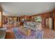 Comfortable living room featuring hardwood floors, area rug, and open access to the kitchen area at 1456 Shavano Ct, Evergreen, CO 80439