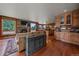 Open-concept living room features wood floors, stone fireplace, and built-in bar area at 1456 Shavano Ct, Evergreen, CO 80439