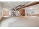 An unfinished basement has concrete floors and exposed ductwork on the ceiling at 5928 N Odessa St, Aurora, CO 80019