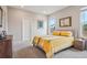 Cozy bedroom with a yellow and white striped bedspread and a bright window at 5928 N Odessa St, Aurora, CO 80019