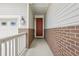 Stylish front entrance featuring a vibrant, solid-wood door, sidelight and charming exterior lighting at 5928 N Odessa St, Aurora, CO 80019