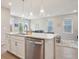 Open-concept kitchen with a view of the living area, featuring an island with a stainless steel dishwasher at 5928 N Odessa St, Aurora, CO 80019