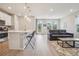 Open concept living space with a kitchen island and a cozy living room area at 5928 N Odessa St, Aurora, CO 80019