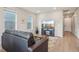 Inviting living room featuring hardwood floors, a comfortable couch, and large windows at 5928 N Odessa St, Aurora, CO 80019