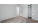 Bedroom featuring neutral carpeting, white walls, closet with sliding doors, and an adjacent room at 3334 N Catawba Way, Aurora, CO 80019