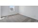 Bright bedroom with neutral carpeting, white walls, and a window offering natural light at 3334 N Catawba Way, Aurora, CO 80019