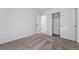 Bedroom featuring neutral carpeting, white walls, closet with sliding doors, and an adjacent room at 3334 N Catawba Way, Aurora, CO 80019