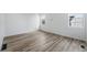 Bright bedroom with wood-look floors and white walls at 3334 N Catawba Way, Aurora, CO 80019