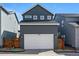 Garage featuring a white garage door with wooden fence on each side at 3334 N Catawba Way, Aurora, CO 80019
