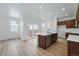 Spacious kitchen featuring a center island with a sink, stainless steel appliances, and hardwood floors at 3334 N Catawba Way, Aurora, CO 80019