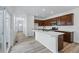 Modern kitchen with white countertops, wood cabinets, stainless steel appliances and light wood floors at 3334 N Catawba Way, Aurora, CO 80019