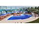 Outdoor pool area featuring a waterslide, lounge chairs, umbrellas, and a clear blue swimming pool at 3334 N Catawba Way, Aurora, CO 80019