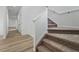 Carpeted staircase leading to the upper level, with light wood floors and white walls in the hallway at 3334 N Catawba Way, Aurora, CO 80019