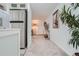 Hallway view showing access to living spaces and a brightly lit entrance at 352 S Lafayette St # 204, Denver, CO 80209