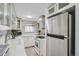 Modern white kitchen featuring stainless steel appliances and stylish backsplash at 352 S Lafayette St # 204, Denver, CO 80209