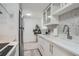 Bright kitchen boasts white cabinetry, stainless appliances, and stylish mosaic backsplash at 352 S Lafayette St # 204, Denver, CO 80209