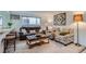 Comfortable living room with leather sofa, patterned chairs, and natural light at 352 S Lafayette St # 204, Denver, CO 80209