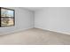 Well-lit bedroom featuring neutral walls and carpet at 8695 Yukon St # F, Arvada, CO 80005