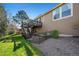 Exterior view of backyard featuring deck, gravel, and healthy lawn at 1053 Snow Lily Ct, Castle Pines, CO 80108