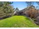 View of the backyard with healthy grass and a home with a deck at 1053 Snow Lily Ct, Castle Pines, CO 80108