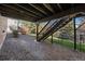 View of gravel beneath deck with stairs leading down at 1053 Snow Lily Ct, Castle Pines, CO 80108