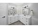 Well-lit bathroom features double sinks and stylish mirrors at 1053 Snow Lily Ct, Castle Pines, CO 80108