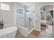 Stylish bathroom showcasing a modern glass shower and a luxurious soaking tub at 1053 Snow Lily Ct, Castle Pines, CO 80108