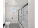 Beautiful bathroom with large subway tiles in shower and geometric patterned tile flooring at 1053 Snow Lily Ct, Castle Pines, CO 80108