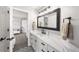 Modern bathroom with striking geometric floor tiles and beautiful quartz countertop at 1053 Snow Lily Ct, Castle Pines, CO 80108