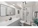 Modern bathroom featuring glass shower, dark fixtures, and ample counter space at 1053 Snow Lily Ct, Castle Pines, CO 80108